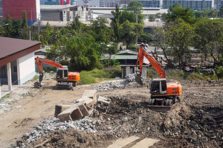 Demolition of building. Excavators breaks old house. Freeing up space for construction of new...
