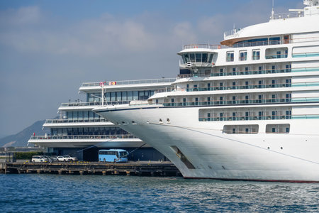 White passenger cruise ship at the pier, a bus and cars are parked nearby. Concept of travel, transfer land and sea transport.の写真素材