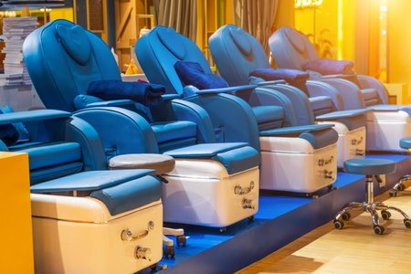 Comfortable soft massage blue chairs for clients with a ottoman for foot massage and other procedures cosmetic careの写真素材