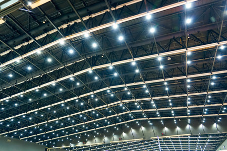Scattered dot directional led lights on rails under the ceiling in a modern large public space warehouse, shopping center building, office or other commercial real estate objectの写真素材
