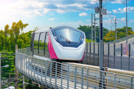 Modern high speed monorail train passes station on the trackの写真素材