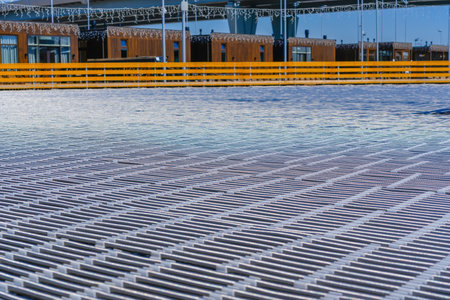 Floor surface with pipes tubes for skating rink temperature and frost maintenance. Laying ice rink support work, installation, dismantling, mobile ice field for hockey street performance summer timeの写真素材