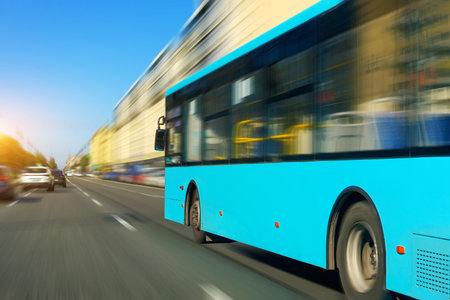 Blue bus view on the road in city rushes motion blur speed effect along the city street on the route.の写真素材