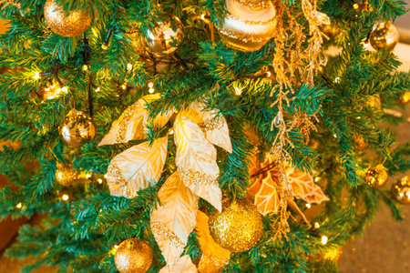 Christmas green tree with New Year toys, gold and yellow balls, leaves foliage.の写真素材