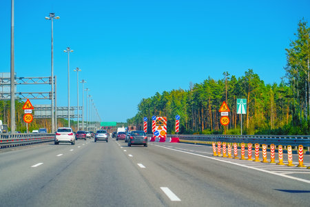 A vibrant highway scene capturing the essence of vehicles gracefully in motion beneath a clear,...