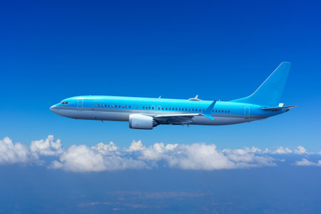 Passenger plane flies and gains altitude through the clouds.の写真素材