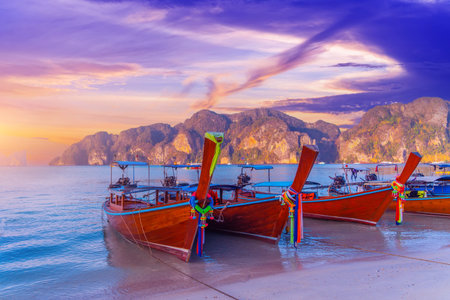 Longtail boats at the beautiful beach Thailand early morning at dawn beautiful sky clouds over bay in the ocean.の写真素材