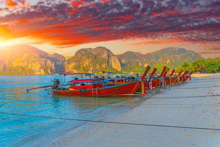 Longtail boats at the beautiful beach Thailand sunset evening at dawn beautiful sky clouds over the ocean.の写真素材