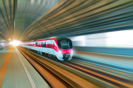 Subway train passes in a station arch tunnel at a passenger station.の写真素材
