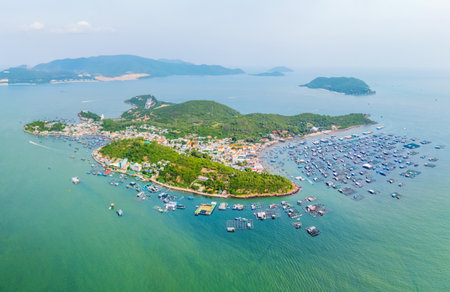 Aerial top view of marine farms structures of aquaculture cages floating, raft for growing marine animals for food. View of fishing village on tropical island Khanh Hoa province.の写真素材
