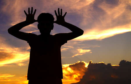 silhouette of a guy making faces            の写真素材