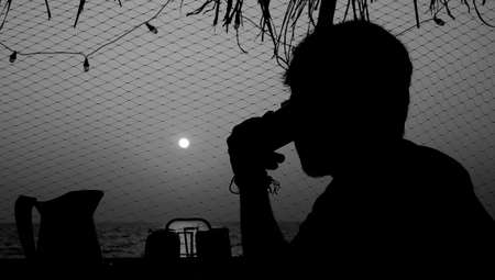 A techie speaking over the phone overlooking a beachの写真素材