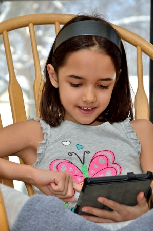 Little Girl Plays Computer Gamesの写真素材