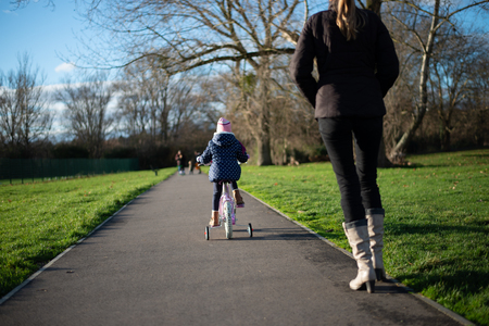Child on the bike on the pathの写真素材