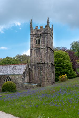 Old church tower on the bluebells meadowの写真素材