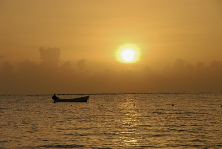 man in the boat during sunset on Adaman seaの写真素材