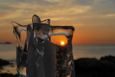 Ice sculpture on the beach during sunsetの写真素材