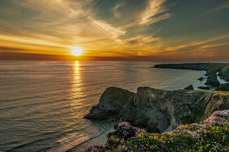 Beautiful dusk sunset of Bedruthan Steps rock stacks in Cornwall, UKの写真素材