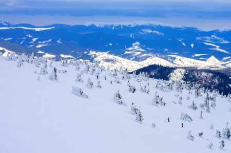 snowy slope of a mountainous area against the backdrop of mountainsの写真素材