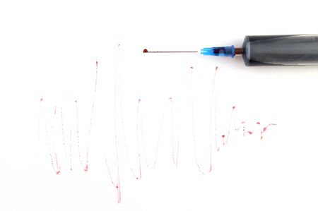 syringe with blood on the background of graphsの写真素材