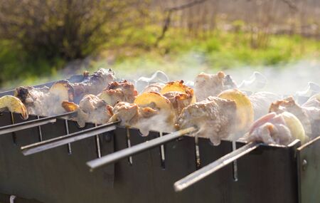 meat on skewers is prepared on the grillの写真素材