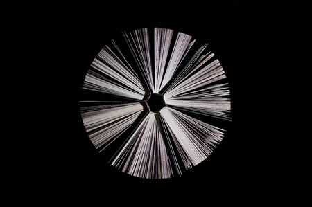 top view of half-opened books on black backgroundの写真素材