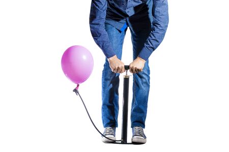 isolate man with a pump pumps up a pink balloon on a white backgroundの写真素材