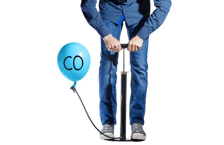on a white background, a pump and a balloon, a man shakes a balloon that says COの写真素材