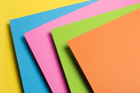 multicolored paper on a yellow backgroundの写真素材