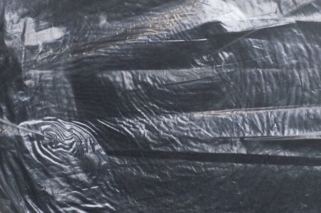 crumpled glossy dark polyethylene texture
