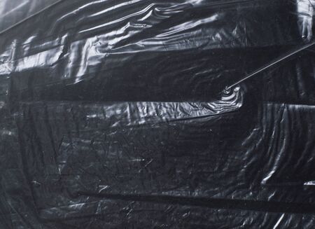 crumpled glossy dark polyethylene texture