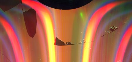 texture of a glossy multi-colored surface of a cd disk with damage