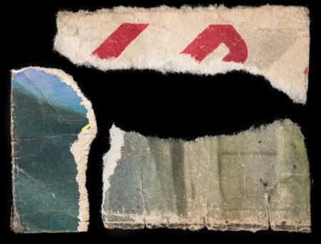 vintage torn pieces of paper on black backgroundの写真素材