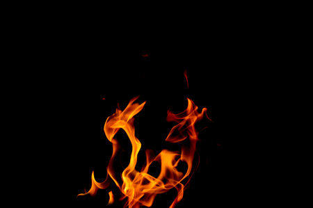 photo of a yellow-orange flame on a black backgroundの写真素材