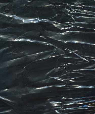 photo texture crumpled polyethylene of a dark shade of colorの写真素材