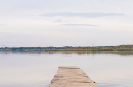 wooden bridge on the background of a body of water