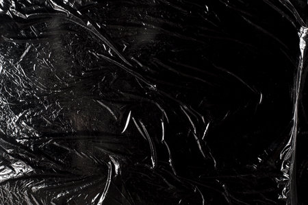texture of dark crumpled polyethylene backgroundの写真素材