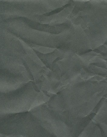 crumpled black paper texture backgroundの写真素材