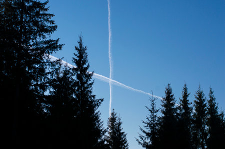 crossed airplane footprints in the skyの写真素材