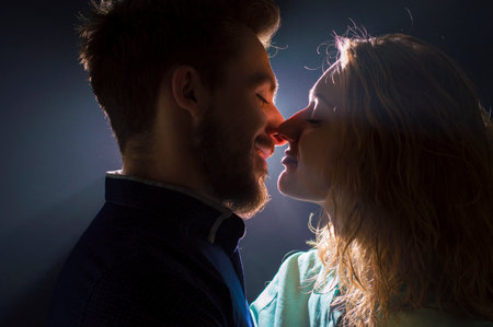 portrait photo of a sexy young couple in pre kiss in streams of lightの写真素材