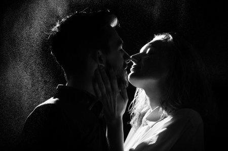 black and white silhouette of a kissing couple