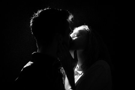 black and white silhouette of a kissing coupleの写真素材