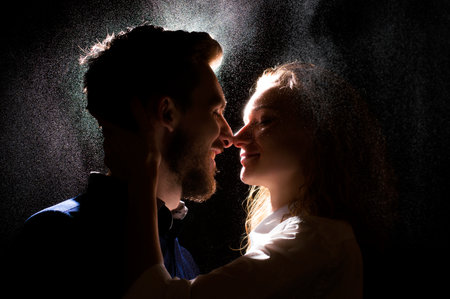 portrait photo of a sexy young couple in a pre kiss under water dropsの写真素材