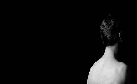 black and white portrait of a guy in the corner of the frameの写真素材