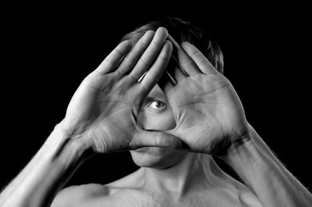 hands folded in a triangle in the face eye in the middleの写真素材