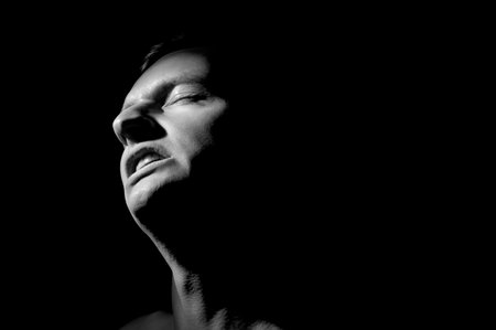 black and white dramatic portrait of a guyの写真素材