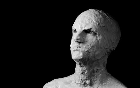 portrait of a shapeless distorted face on a black backgroundの写真素材