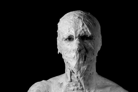 portrait of a shapeless distorted face on a black backgroundの写真素材