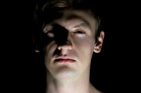 portrait of a guy in dramatic lightingの写真素材