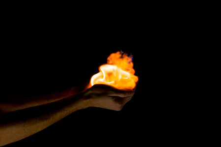 fire in hand on a black backgroundの写真素材